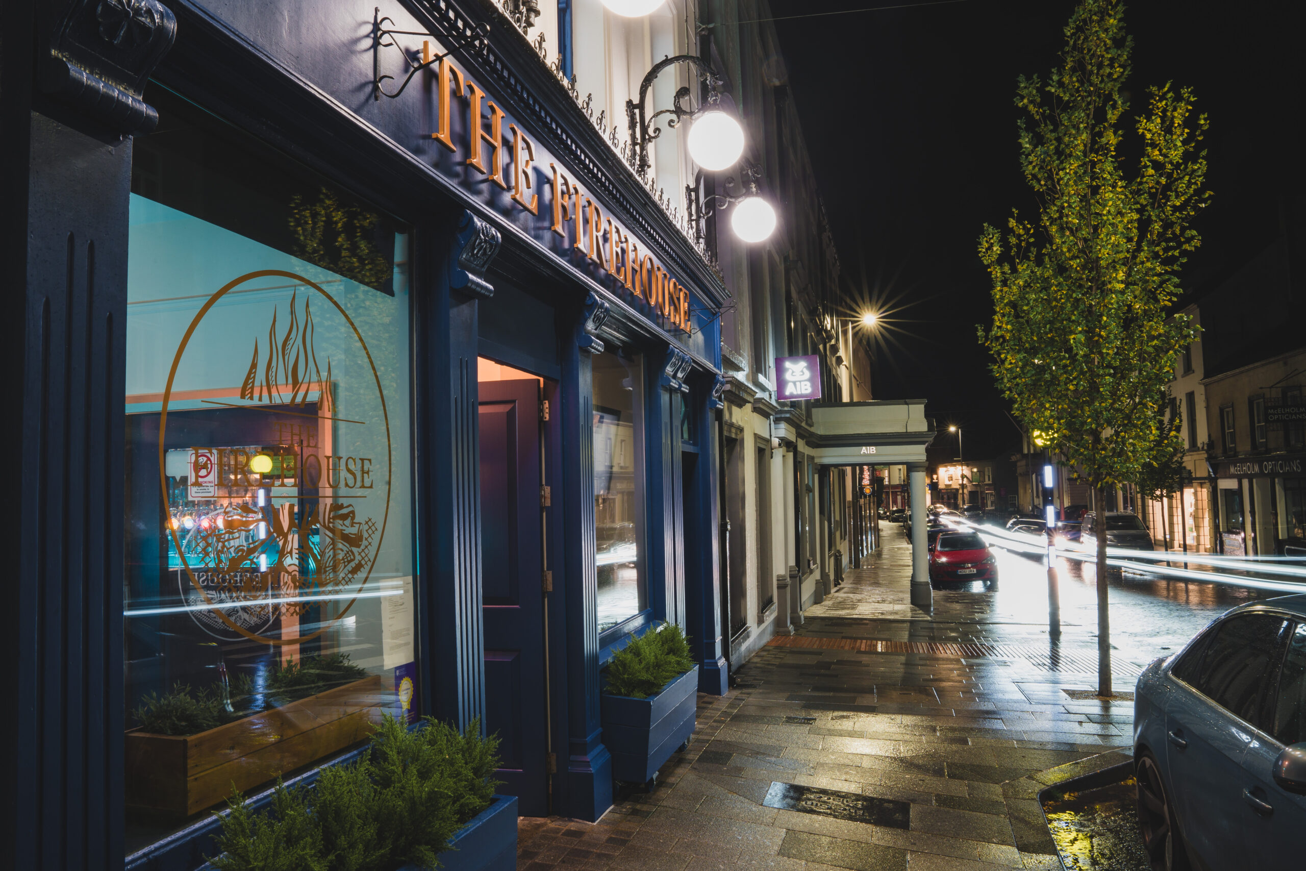 Front of The Firehouse Enniskillen restaurant lit up at night. food before a night out enniskillen